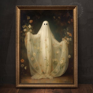 May include: A white ghost figure wearing a sheer white gown with floral patterns, standing in a dark, floral background. The ghost has two black eyes and is framed in a gold ornate frame.