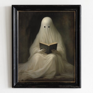May include: A framed print featuring a ghost draped in white fabric, reading a book. The ghost has two black eye holes. The print is in a black frame with the text "Uncanny Gardens" at the top. The overall theme is spooky and literary.