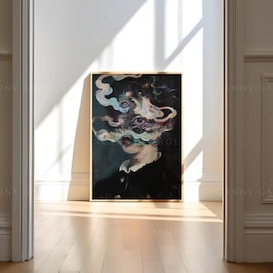 May include: A framed artwork featuring a surreal portrait with a dark color palette. The subject's face is partially obscured by swirling, colorful smoke-like forms. The artwork is displayed in a bright room with sunlight.