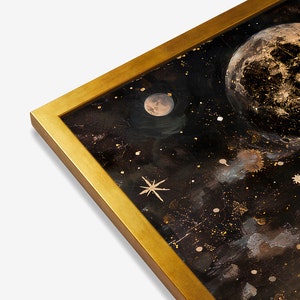 May include: A framed painting of a dark night sky with a large, full moon and smaller moon in the upper left corner. The sky is filled with gold glitter and stars.