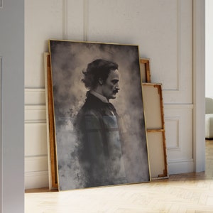 May include: A framed portrait of a man with dark hair and a mustache. The portrait is in a gold frame and is set against a white wall.
