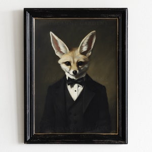 May include: Framed artwork featuring a dapper fox in a black tuxedo and bow tie. The fox has large ears and a refined expression. The artwork is set against a dark background and framed in a distressed black frame. The text "UNCANNY GARDENS" is visible.