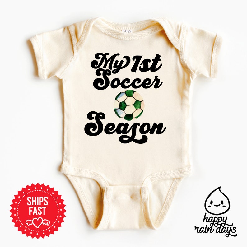 a baby bodysuit with the words my 1st soccer season printed on it