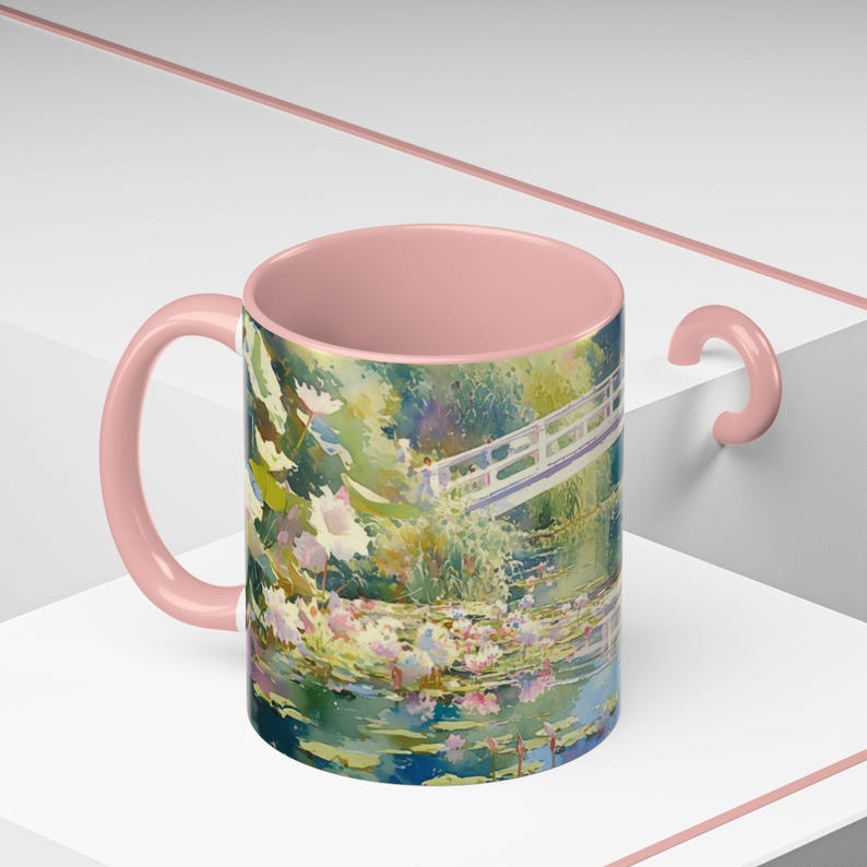 Artistic mug featuring Monet’s water lilies and Japanese bridge, showcasing serene greens, soft pinks, and calm reflections inspired by his iconic garden scenes
