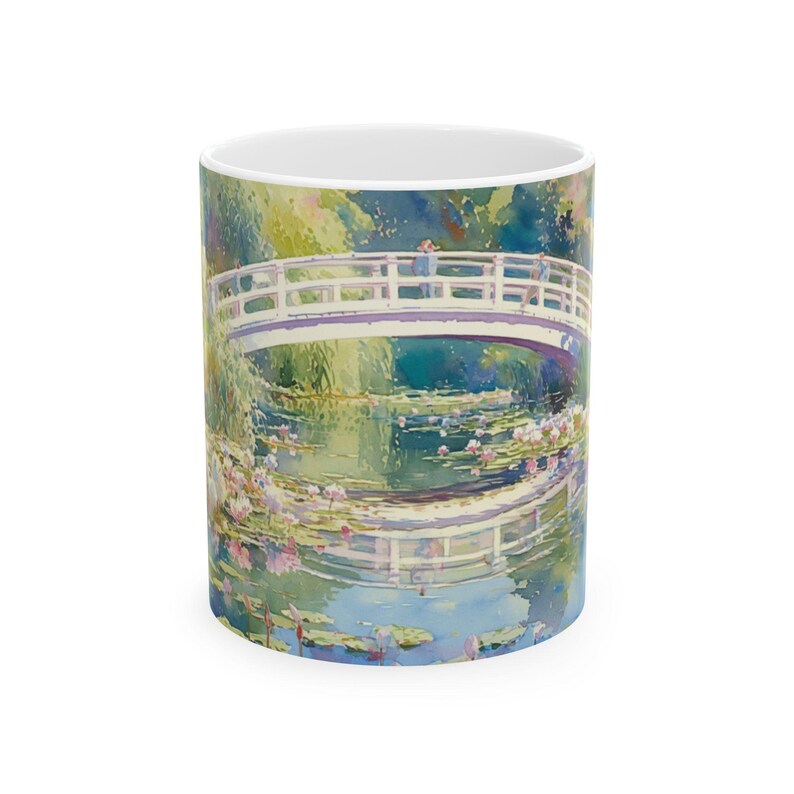 Artistic mug featuring Monet’s water lilies and Japanese bridge, showcasing serene greens, soft pinks, and calm reflections inspired by his iconic garden scenes