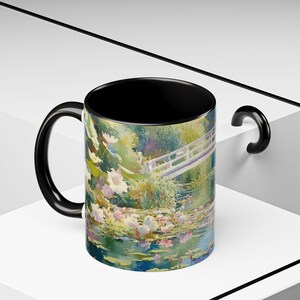 Artistic mug featuring Monet’s water lilies and Japanese bridge, showcasing serene greens, soft pinks, and calm reflections inspired by his iconic garden scenes
