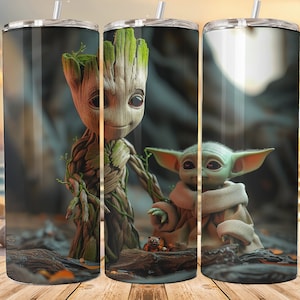 May include: Two stainless steel tumblers with a graphic of a green alien and a tree-like creature. The background is a blurred image of a beach and sunset.
