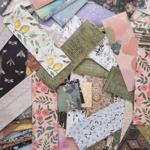 May include: A collection of colorful patterned paper scraps, featuring floral, geometric, and abstract designs. The paper scraps are arranged in a random pattern, creating a visually appealing collage.