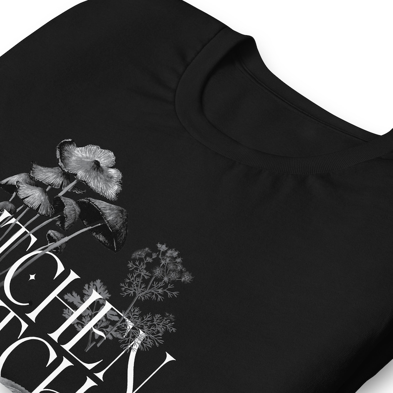 May include: Black t-shirt with a white graphic of mushrooms and a sprig of dill. The text "Shroom Queen" is printed on the shirt.