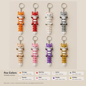 May include: Eight articulated fox keychains in orange, red, white, gray, beige, pink, purple, and golden colors. Each fox features a white chest, white tail tip, and a metal keyring. Text at the bottom lists Fox Colors and printable variants.