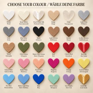 May include: A color chart featuring thirty heart-shaped swatches arranged in five rows of six. The text CHOOSE YOUR COLOUR / W&Auml;HLE DEINE FARBE appears at the top. Each heart is labeled with its corresponding color name in English and German.