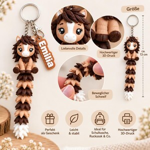 May include: A brown and tan horse keychain with a long, articulated, flexible tail and a white tip. The keychain includes a metal ring and a rectangular tag with the name Emilia printed in white. The total length is approximately 13 cm.