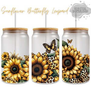 May include: Three stainless steel tumblers with a white background and a design of sunflowers, butterflies, and leopard print. The tumblers have a bamboo lid and a straw.