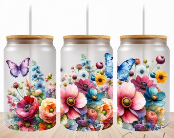 May include: Three clear glass tumblers with bamboo lids and straws. Each tumbler features a colorful floral design with butterflies. The flowers are pink, yellow, orange, blue, and purple. The butterflies are blue, purple, and yellow.