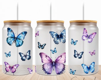 May include: Three clear glass tumblers with bamboo lids and straws, each featuring a different design of watercolour butterflies in shades of blue, purple, and pink.