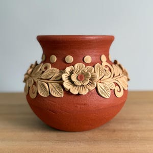 May include: A set of three ceramic mugs with a speckled, matte finish. The mugs are in shades of cream, light gray, and dark gray. Each mug has a simple, minimalist design, perfect for coffee or tea.