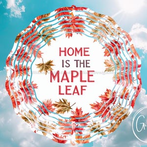 May include: A white circular wind chime with a blue and brown border. The wind chime features a watercolour design of red and orange maple leaves. The text "Home is the Maple Leaf" is printed in red on the wind chime.
