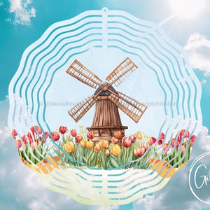May include: A watercolor illustration of a Dutch windmill surrounded by colorful tulips. The windmill is brown with large blades, set against a blue sky with clouds. The design is framed by a white, wavy border. The text "Gillian's Design Studio" is in the lower right.
