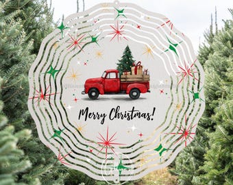 May include: A decorative Christmas ornament featuring a red pickup truck carrying a Christmas tree and gifts. The ornament has a wavy, circular design with the words "Merry Christmas!" and festive star accents.