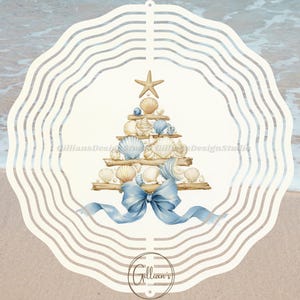 May include: A decorative, cream-colored wind spinner with a beach theme. The design features a Christmas tree shape made of seashells, a starfish, and a blue bow. The background shows a sandy beach and ocean waves.