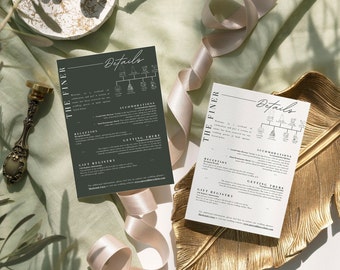 May include: Two wedding details cards with the text "Details" and "The Finer" in elegant script. One card is dark green, the other is white. The cards include information about the wedding, with a gold decorative tray and ribbon in the background.