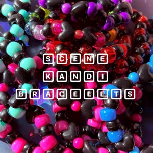 May include: A collection of colorful beaded bracelets. The bracelets feature a variety of beads in shades of black, pink, blue, teal, and purple. The text "SCENE KANDI BRACELETS" is displayed in white block letters.