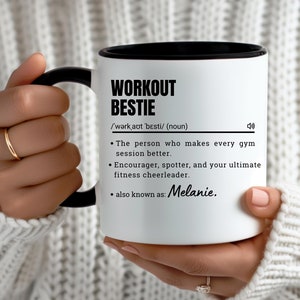 May include: White coffee mug with a black rim and handle. The mug has black text that reads "WORKOUT BESTIE /wark aut besti/ (noun) 40 • The person who makes every gym session better. • Encourager, spotter, and your ultimate fitness cheerleader. • also known as: Melanie."