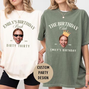 May include: Two white t-shirts with a custom birthday party design. The left shirt says "Emily's Birthday Bash Dirty Thirty" with a photo of a woman wearing sunglasses. The right shirt says "The Birthday Club Est. 1995 Emily's Birthday" with a photo of a woman wearing a crown.