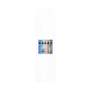 May include: White bookmark with a colorful rectangular design. The design features vertical stripes in blue, pink, green, and purple, with the word "The KNOBS" in black. Abstract black lines overlay the stripes.
