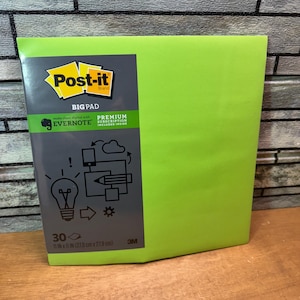 May include: A bright green Post-it Big Pad. The pad is 11 in x 11 in (27.9 cm x 27.9 cm) and features the Post-it brand logo and Evernote branding. The packaging includes a premium subscription. The pad has 30 sheets.