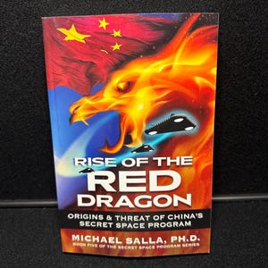 以下が含まれることがあります： 「Rise of the Red Dragon」というタイトルの本で、炎のドラゴンのイラストが描かれています。表紙には赤と黄色のドラゴン、中国の国旗、そして「Origins & Threat of China's Secret Space Program」というテキストが描かれています。