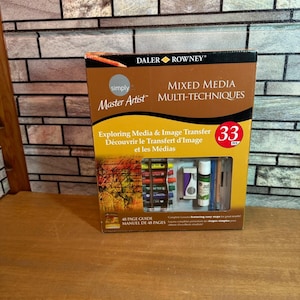 May include: A Daler-Rowney Simply Master Artist mixed media multi-techniques art set. The box contains 33 pieces, including art supplies and a 48-page guide. The box is brown and orange with the product name and details printed on the front.