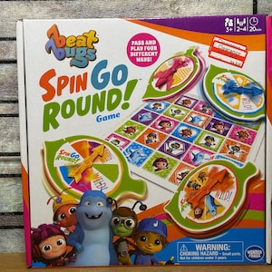 May include: A colorful Beat Bugs Spin Go Round! board game box. The box features cartoon characters and game components, including spinners and a game board. The text on the box reads "Spin Go Round! Game". The game is for 2-4 players and takes 20 minutes to play.