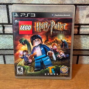 Pode incluir: Capa do jogo PlayStation 3 para "LEGO Harry Potter: Anos 5-7". A capa apresenta versões LEGO dos personagens de Harry Potter, uma cobra verde e o título do jogo. O jogo é classificado como "Para todos com 10+" pela ESRB.