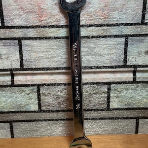 May include: A silver wrench with a 5/8 inch opening. The wrench is labeled "Snap-on 12-point 1/2".