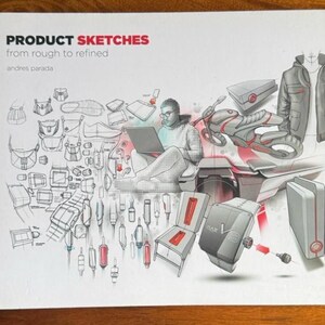 May include: A book titled "PRODUCT SKETCHES from rough to refined" by Andres Parada. The cover features product design sketches, including a motorcycle, jacket, watch, and chair, with a person using a laptop.