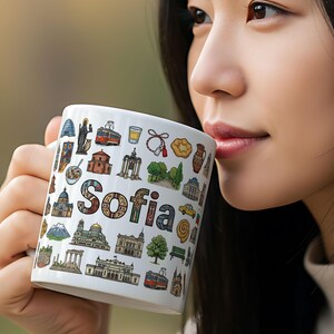 May include: A set of three ceramic mugs with a speckled, matte finish. The mugs are in shades of cream, light gray, and dark gray. Each mug has a simple, minimalist design and a rounded handle.