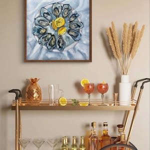 May include: A watercolor painting of a plate of oysters and lemon wedges. The oysters are arranged in a circle around the plate, and the lemon wedges are placed in the center. The painting is framed in a brown wood frame.