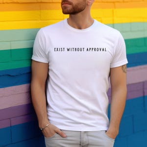 May include: White t-shirt with the text "EXIST WITHOUT APPROVAL" printed in black on the front.