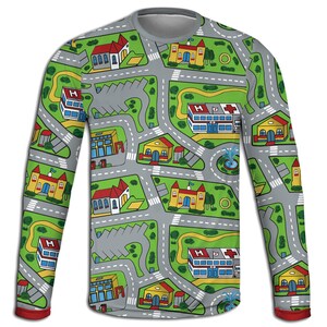 May include: A long-sleeved shirt featuring a colorful city map design. The shirt has a gray base with roads, buildings, and green spaces. The sleeves have a red trim at the cuffs. The design includes hospitals, churches, and houses.