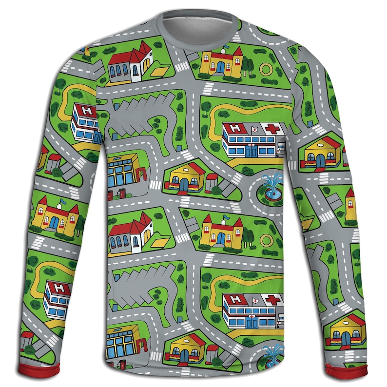 May include: A long-sleeved shirt featuring a colorful city map design. The shirt has a gray base with roads, buildings, and green spaces. The sleeves have a red trim at the cuffs. The design includes hospitals, churches, and houses.