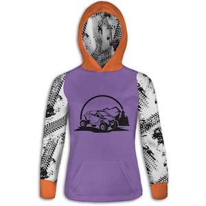 May include: A purple hoodie with an orange hood and cuffs. The sleeves are white with black tire track patterns. The front features a black graphic of an off-road vehicle, mountains, and a semi-circle.