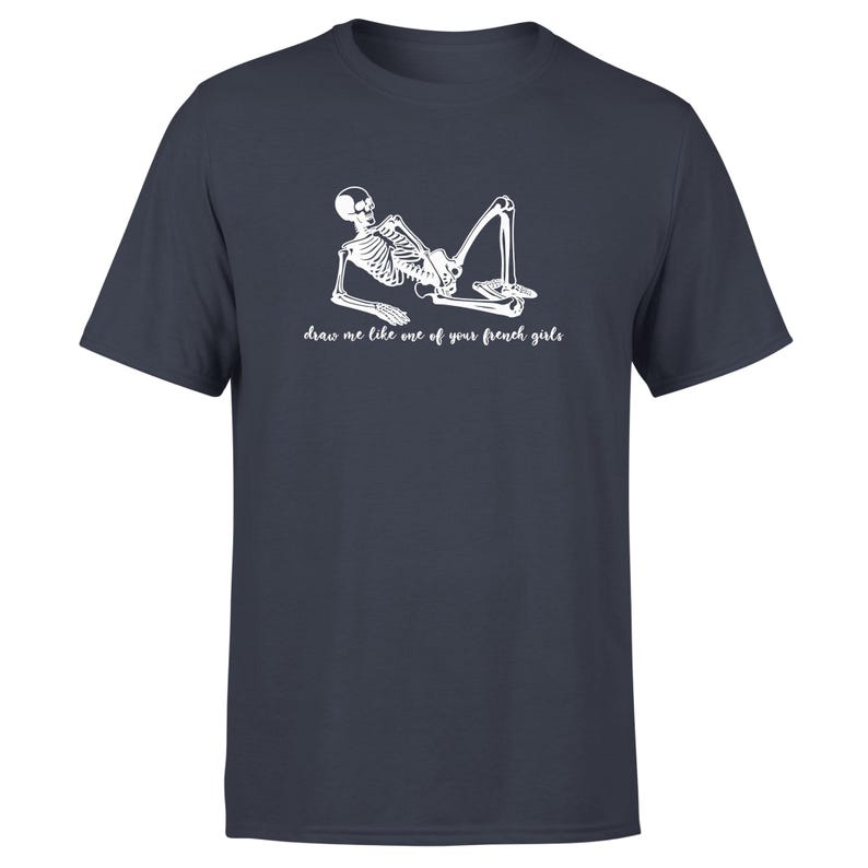May include: A dark blue t-shirt with a white skeleton graphic and the text "draw me like one of your french girls".