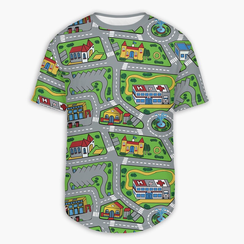 May include: A gray, short-sleeved t-shirt featuring a colorful city map design. The map includes roads, buildings, parking lots, and fountains. Buildings include a hospital, church, and houses. The shirt has a rounded hem.