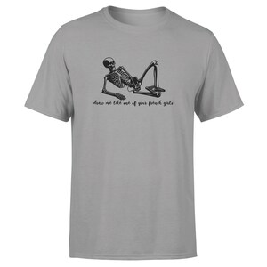 May include: A gray t-shirt with a black skeleton illustration and the text "draw me like one of your french girls".