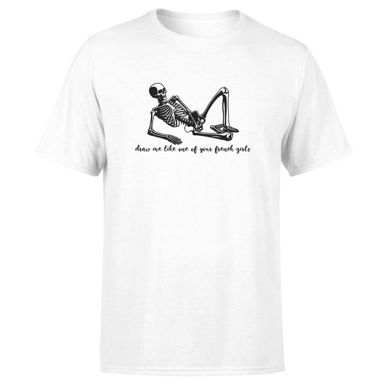 May include: White t-shirt with a black skeleton graphic and the text "draw me like one of your french girls".