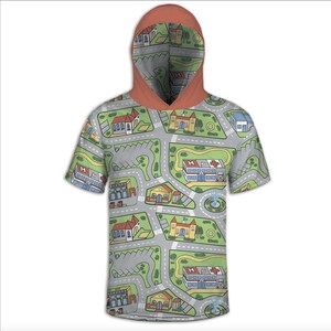 May include: A short-sleeved hooded shirt featuring a playful city map design. The shirt's pattern includes roads, buildings, parking lots, and green spaces. The hood is a solid orange-brown color, providing a contrast to the map design.