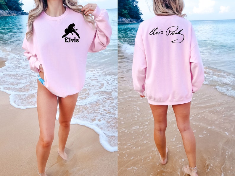 May include: Pink sweatshirt with a black silhouette of Elvis Presley playing a guitar on the front and his signature on the back.