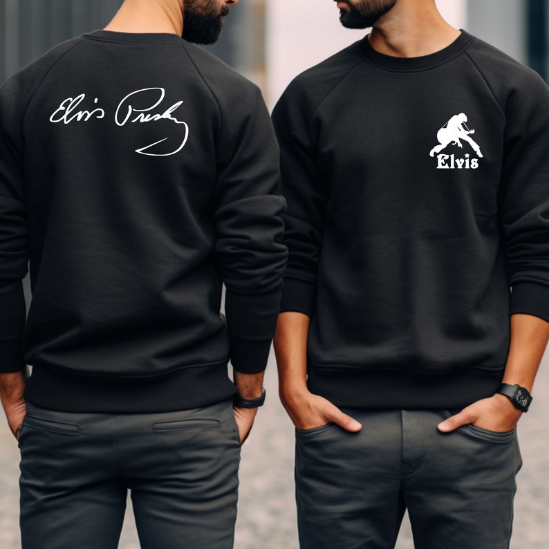 May include: Two black sweatshirts with white designs. One sweatshirt has a white signature that says "Elvis Presley" on the back. The other sweatshirt has a white silhouette of Elvis Presley playing a guitar with the word "Elvis" underneath.