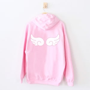 May include: A pink hoodie with a white angel wing design on the back.